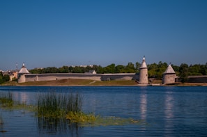 A serene landscape of a historical fortress at sunset.