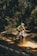 Close-up of a dirt bike rider navigating a challenging off-road trail.