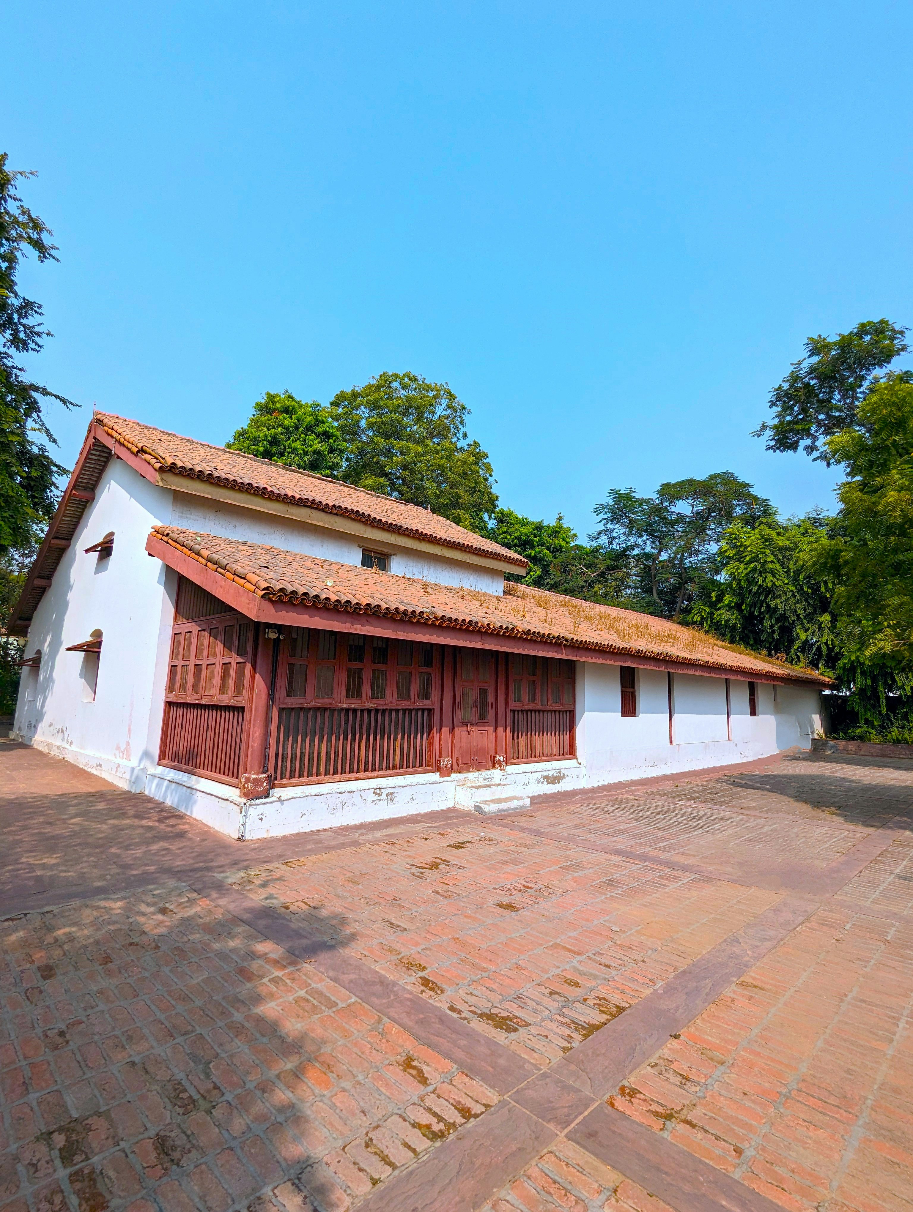 a white building with a red roof and a red door