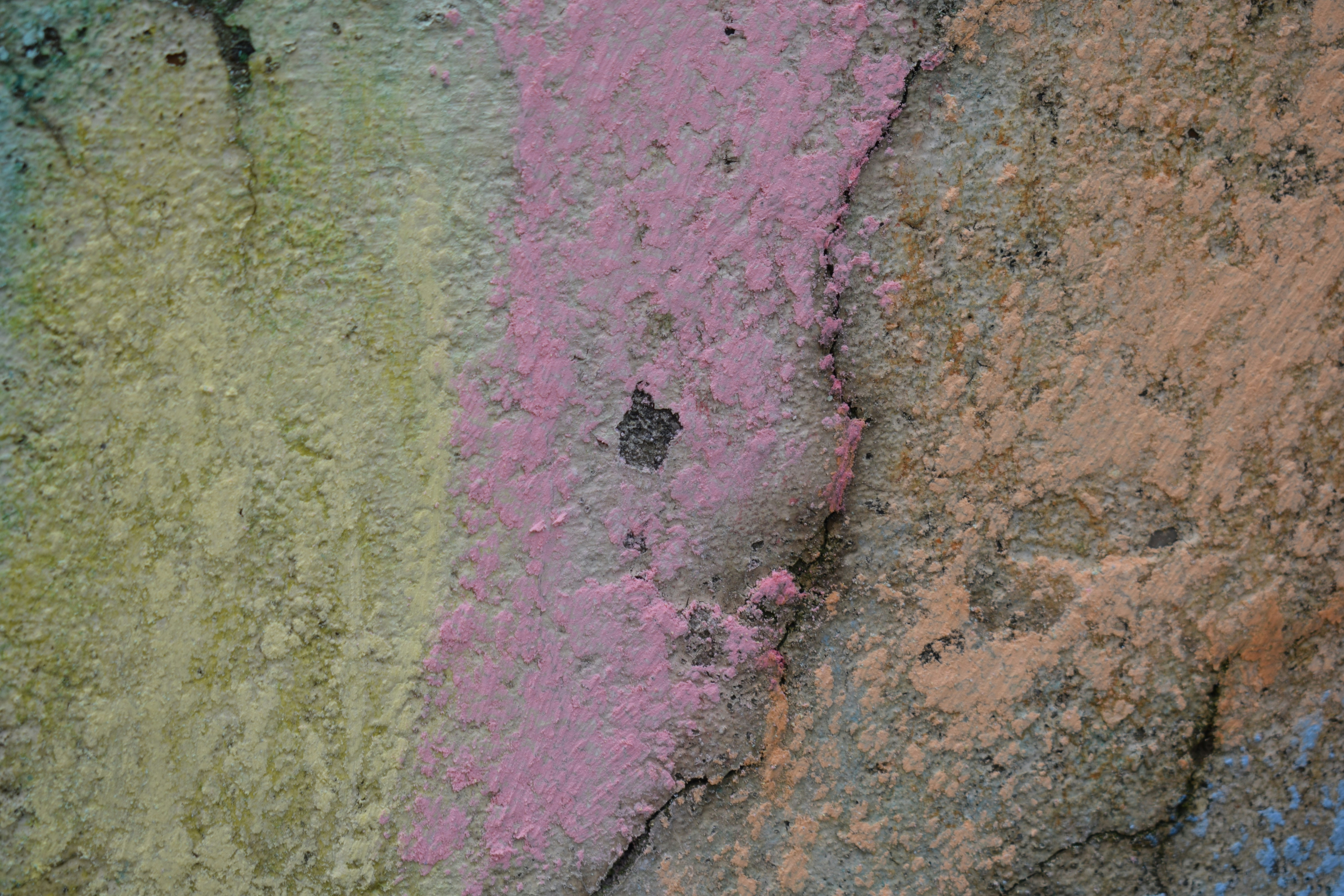 a close up of a rock wall with different colors
