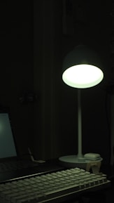 A stylish dark-themed workspace with laser engraving equipment glowing softly in ambient light.