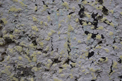 Close-up of textured wall paint and decorative exterior elements on a home.