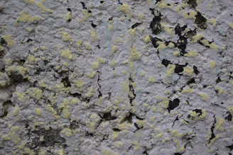 Close-up-photo-of-cracked-and-poorly-plastered-wall-with-uneven-paint-patches-webp