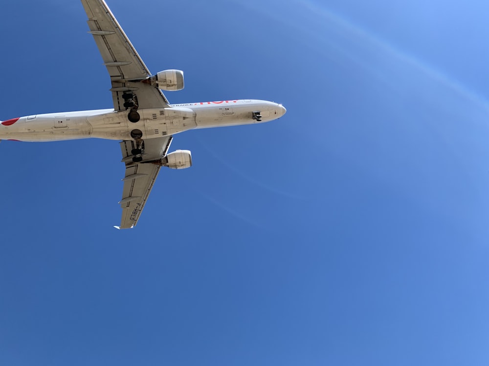 a large jetliner flying through a blue sky