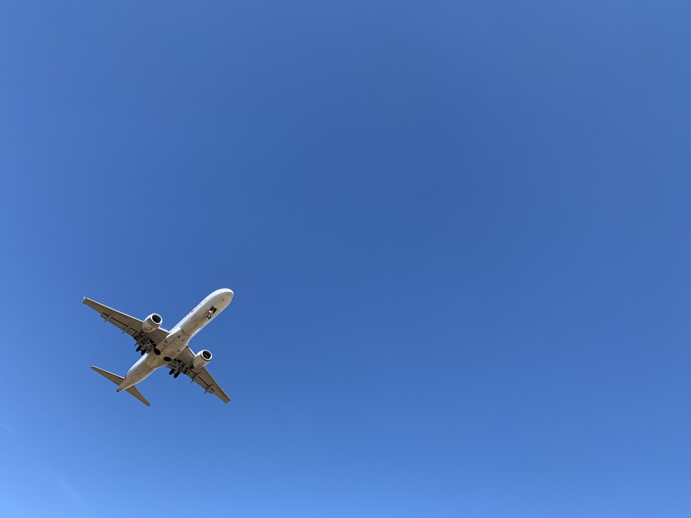 a large jetliner flying through a blue sky