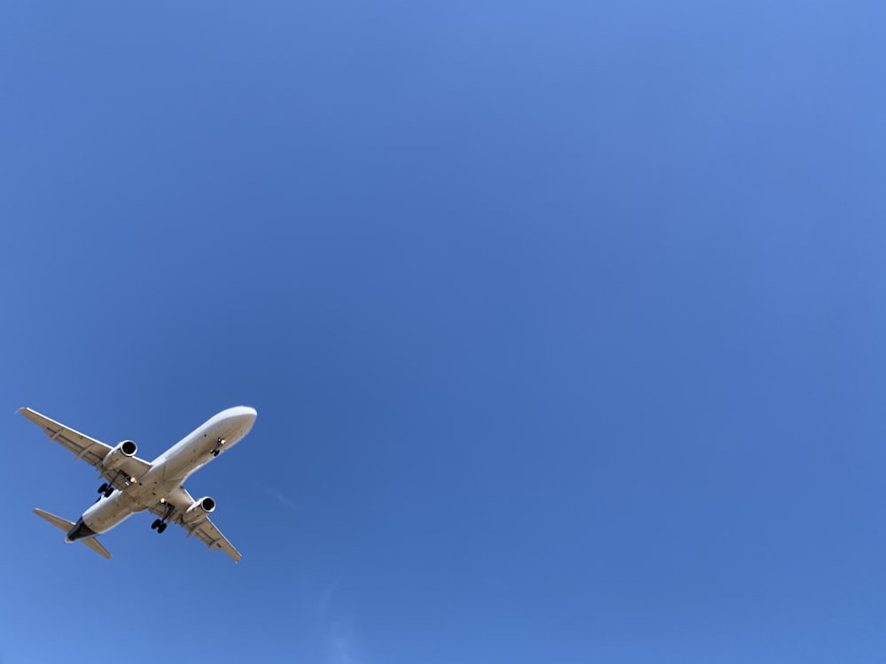 a large jetliner flying through a blue sky