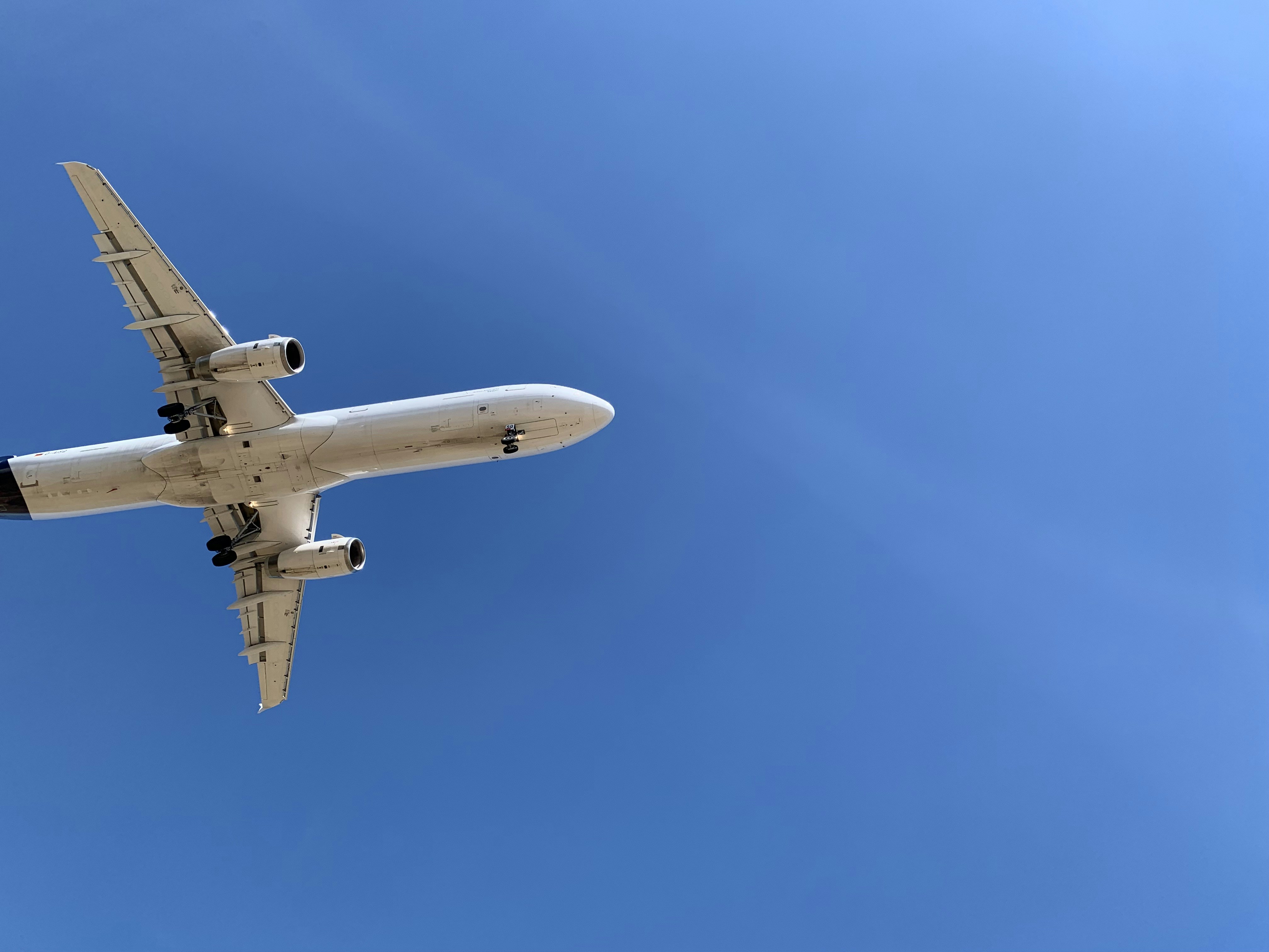 a large jetliner flying through a blue sky, Plane landing at Manises airport, Valencia, Spain, Europe