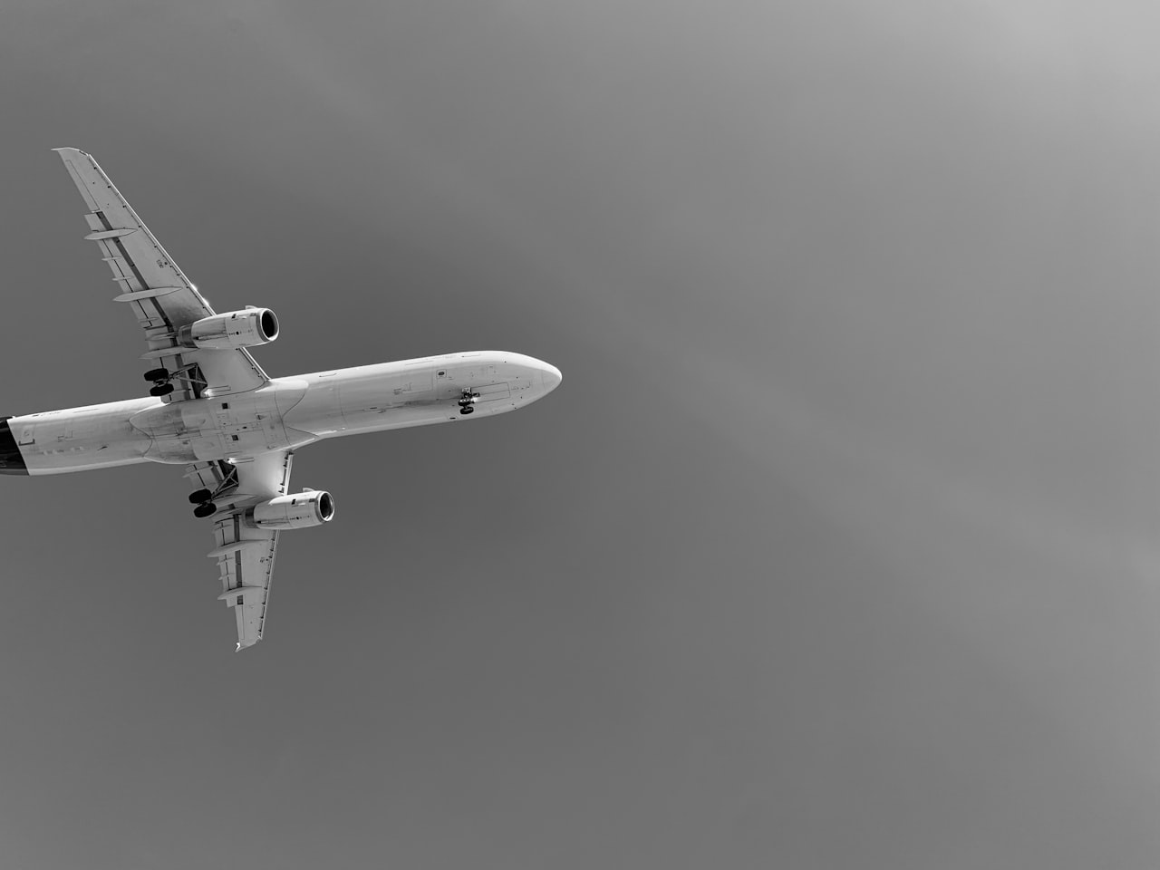 a large jetliner flying through a blue sky