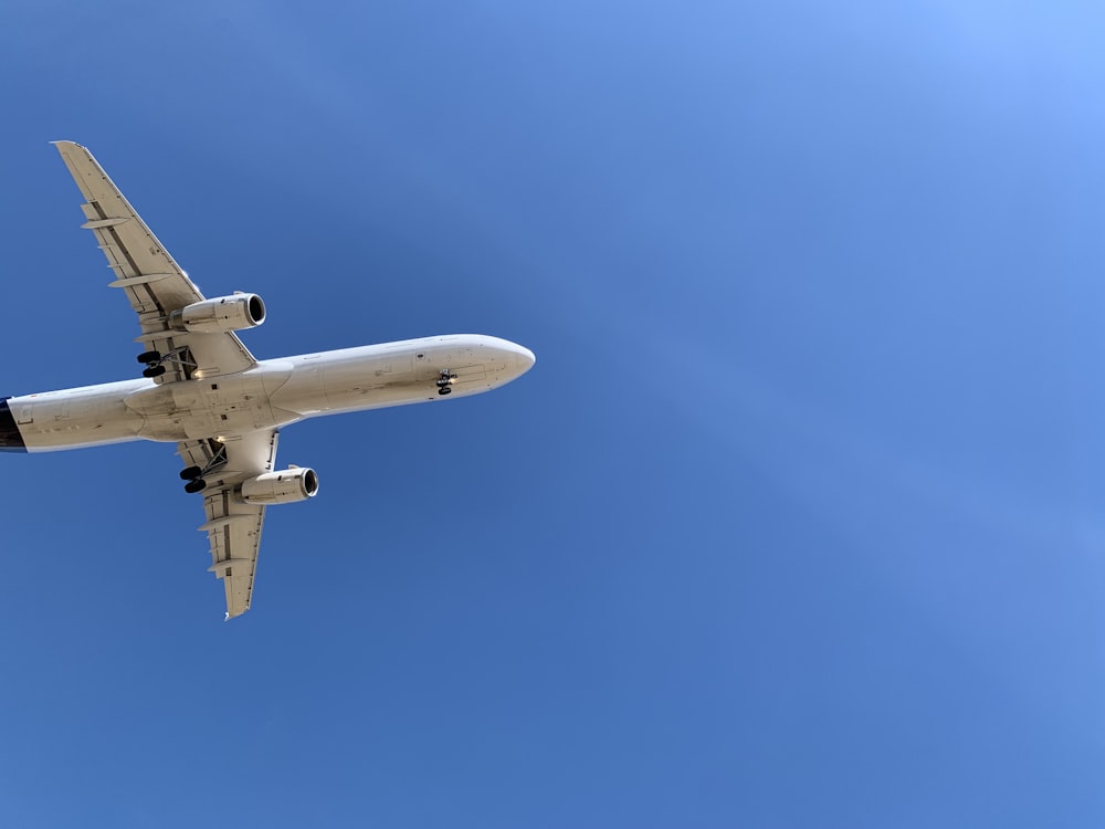 a large jetliner flying through a blue sky