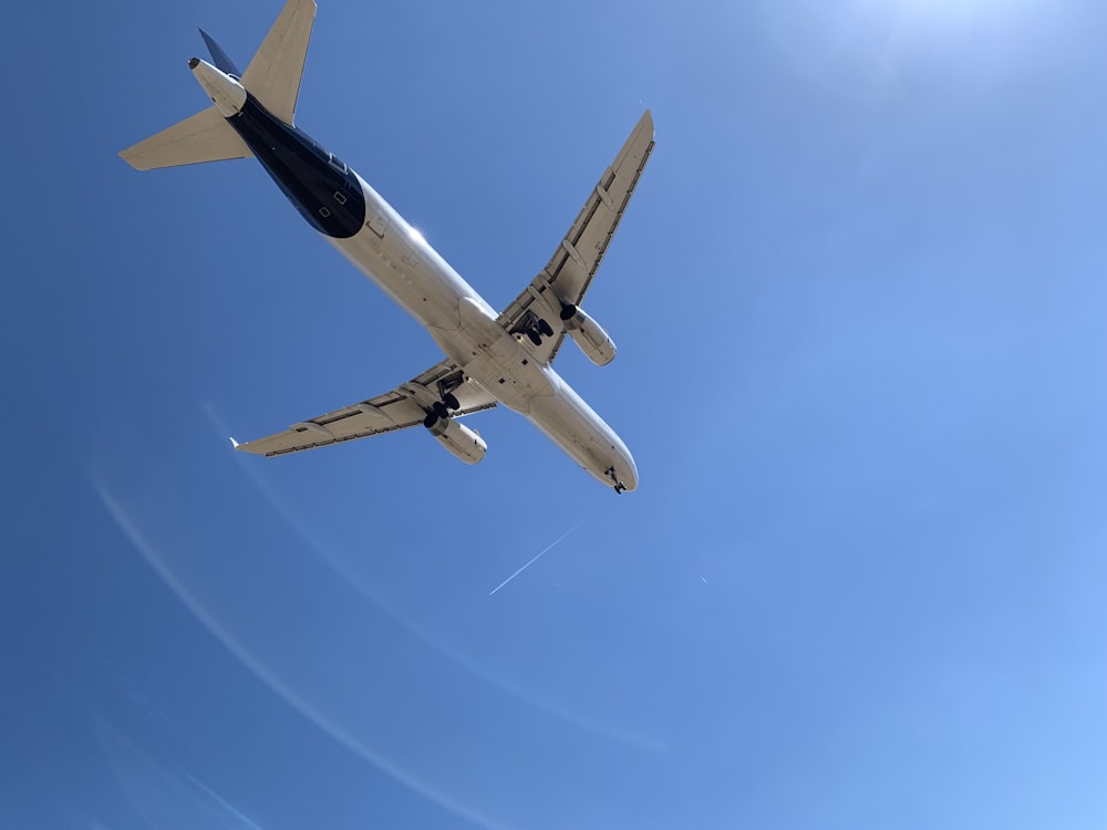 a large jetliner flying through a blue sky