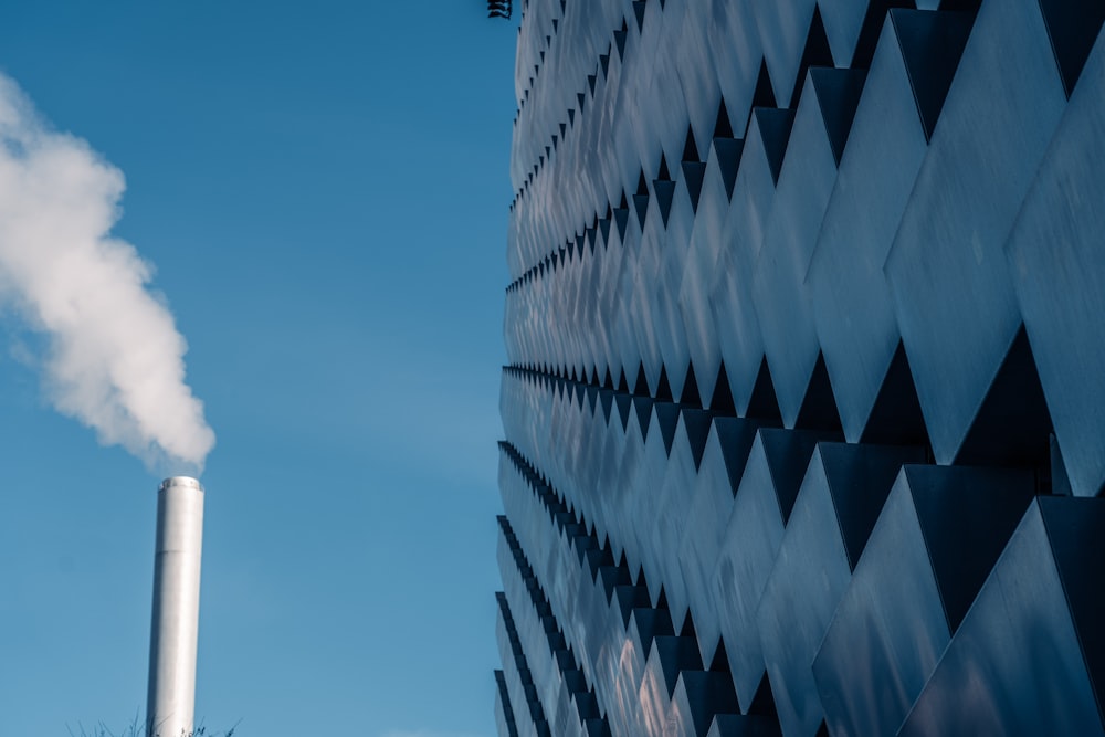 smoke coming out of a chimney in front of a building