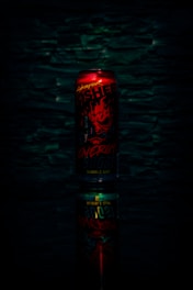 A vibrant can of neverdragme energy drink surrounded by dynamic splashes of energy and light.