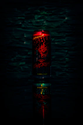 A vibrant can of Divorox energy drink with splashes of flavor bursting around it.