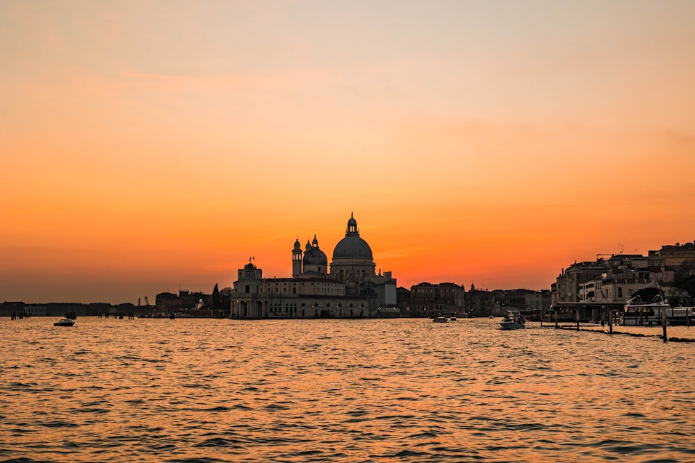 a large body of water with buildings in the background