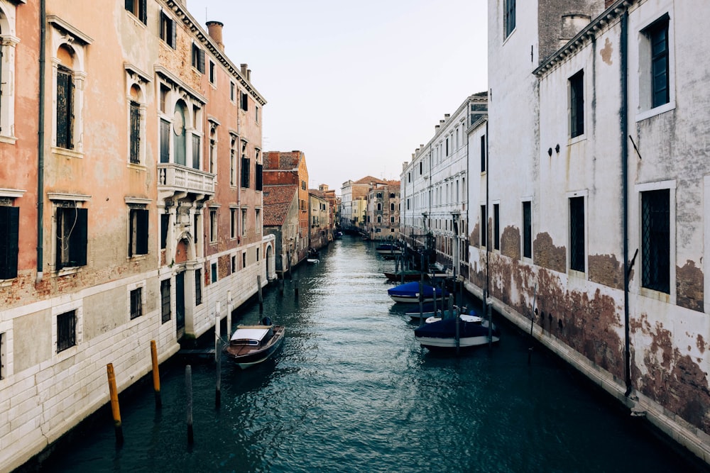 a narrow canal with several boats in it