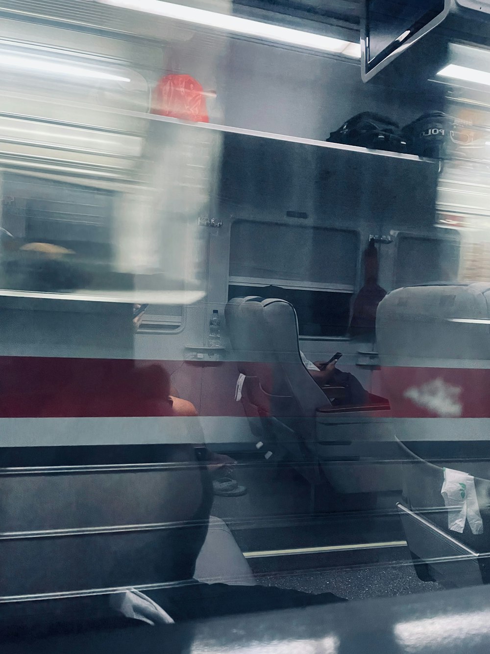a blurry photo of a train with people sitting on seats