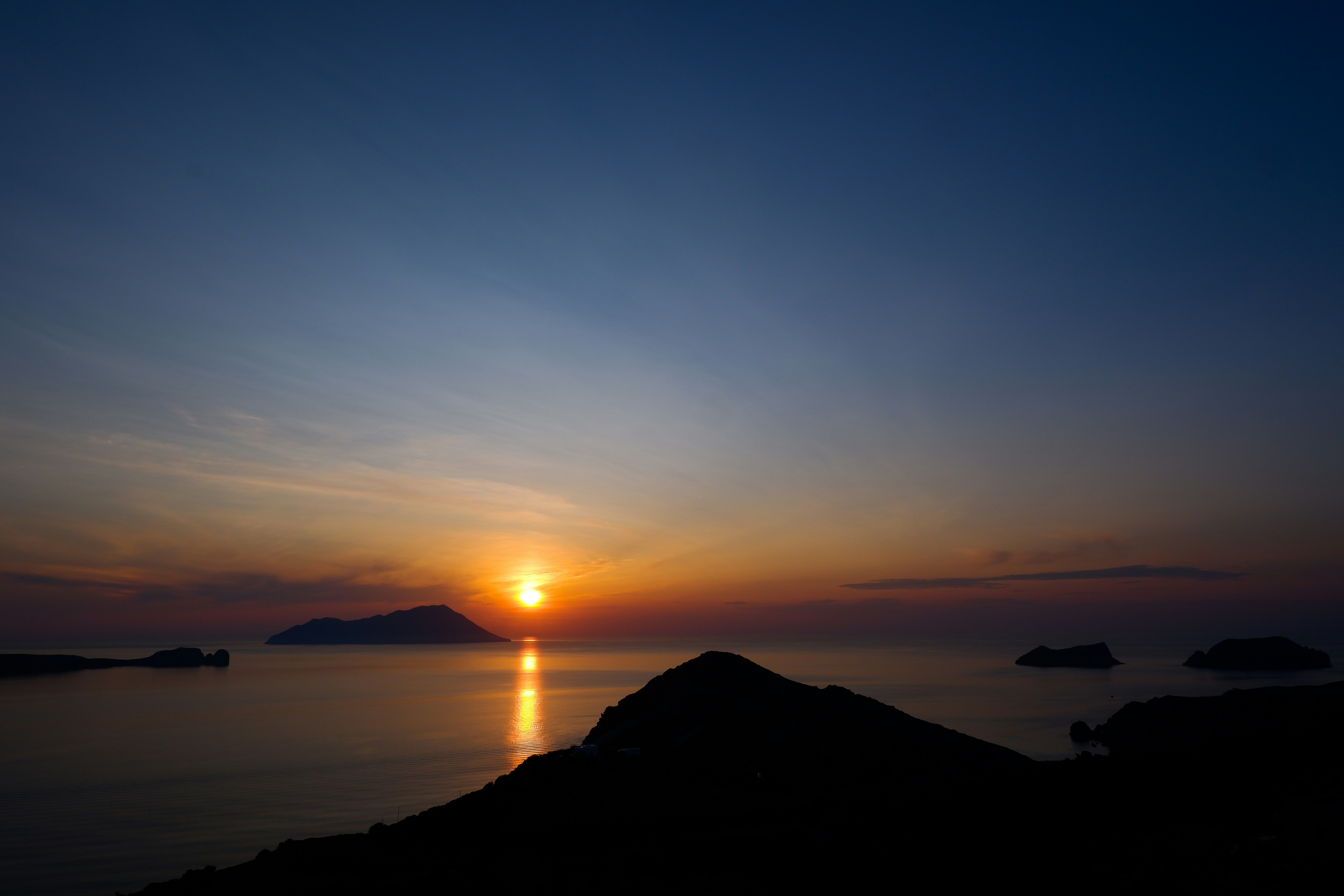 the sun is setting over a body of water