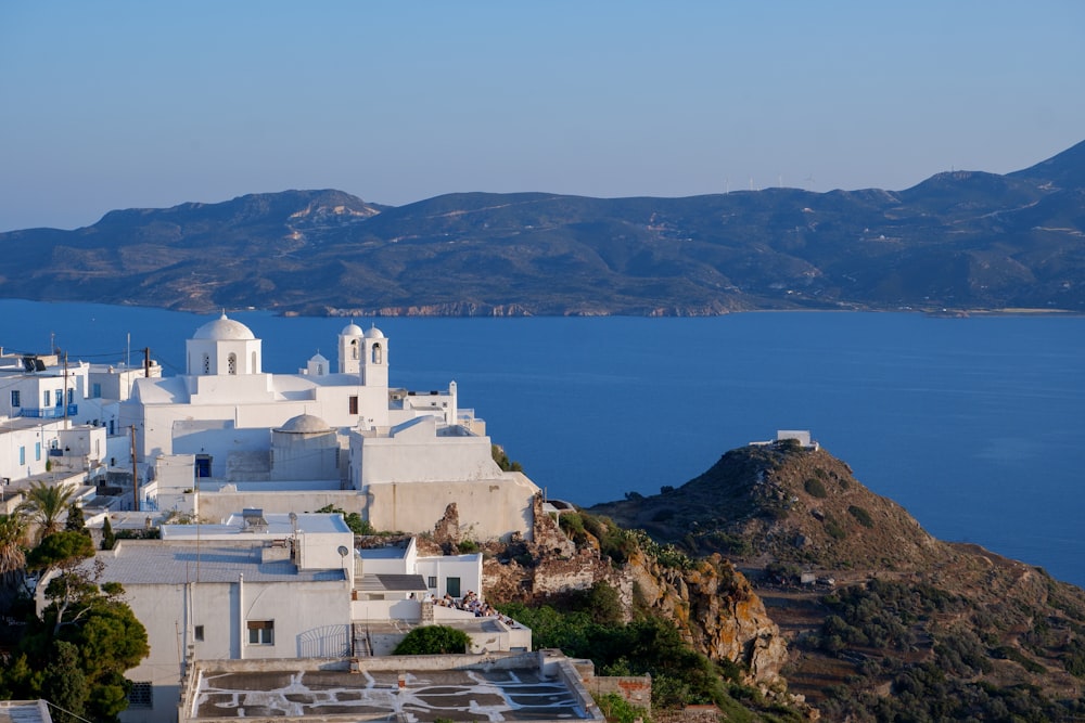 a view of a small village on a cliff overlooking a body of water