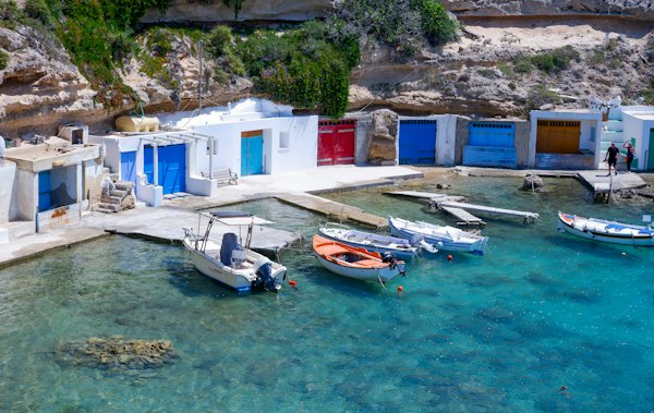 A bunch of boats that are sitting in the water — Milos, Greece