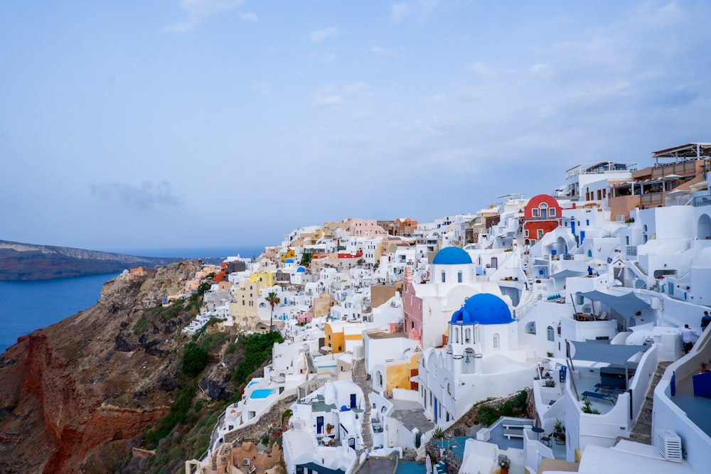 a scenic view of a village on a cliff overlooking the ocean