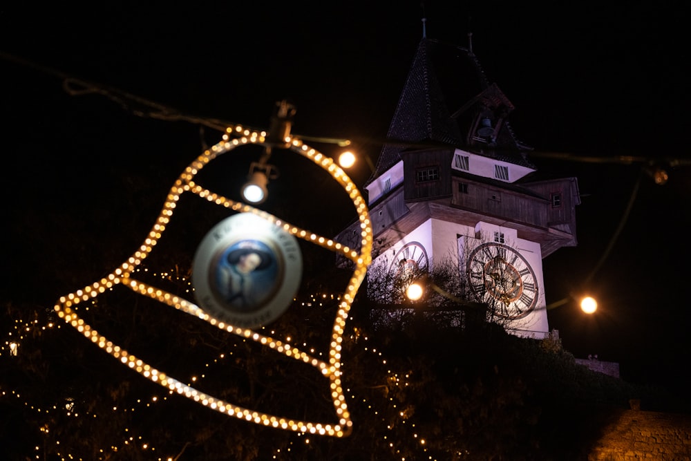 a bell tower with a clock on it at night