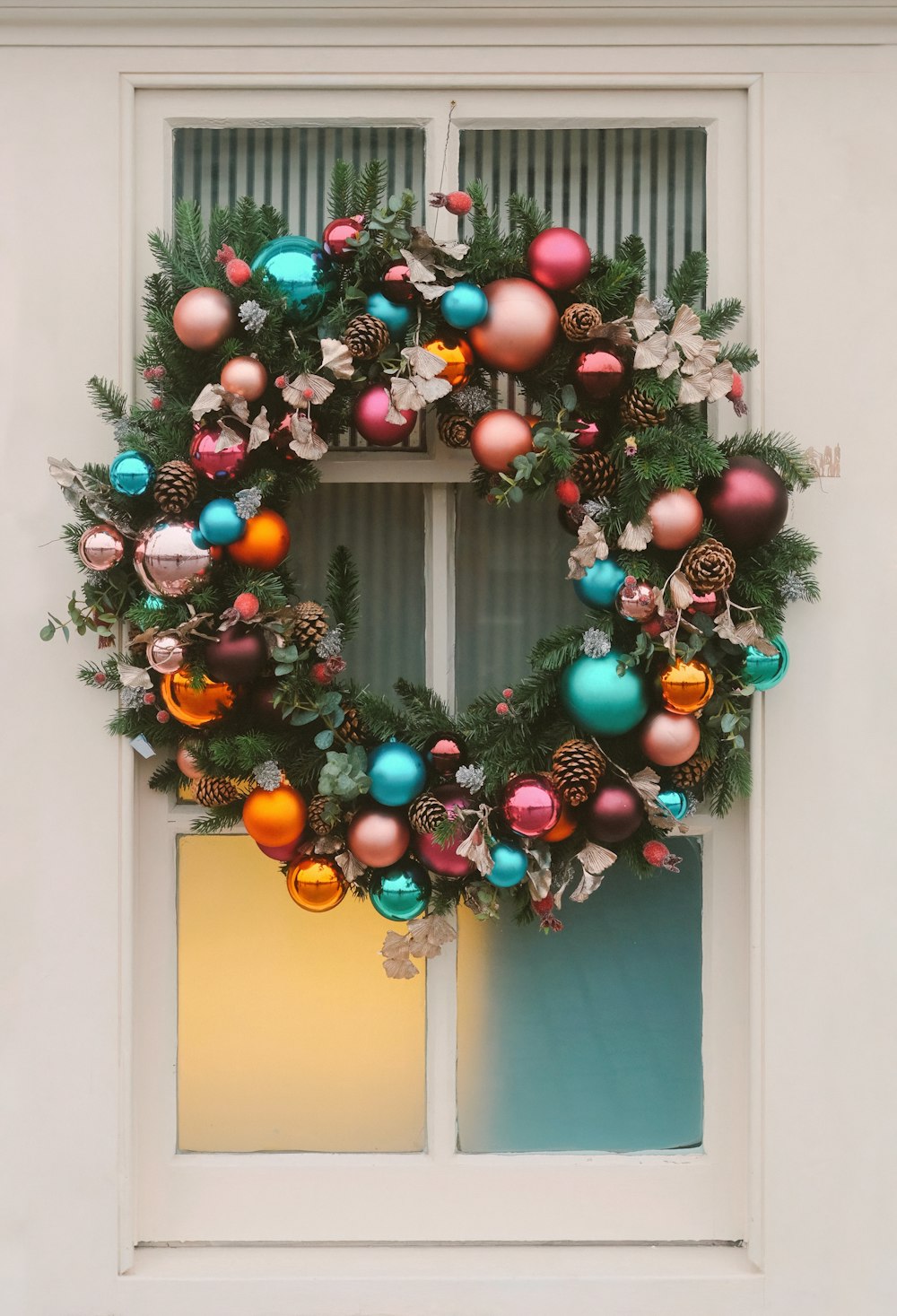a christmas wreath on a window sill