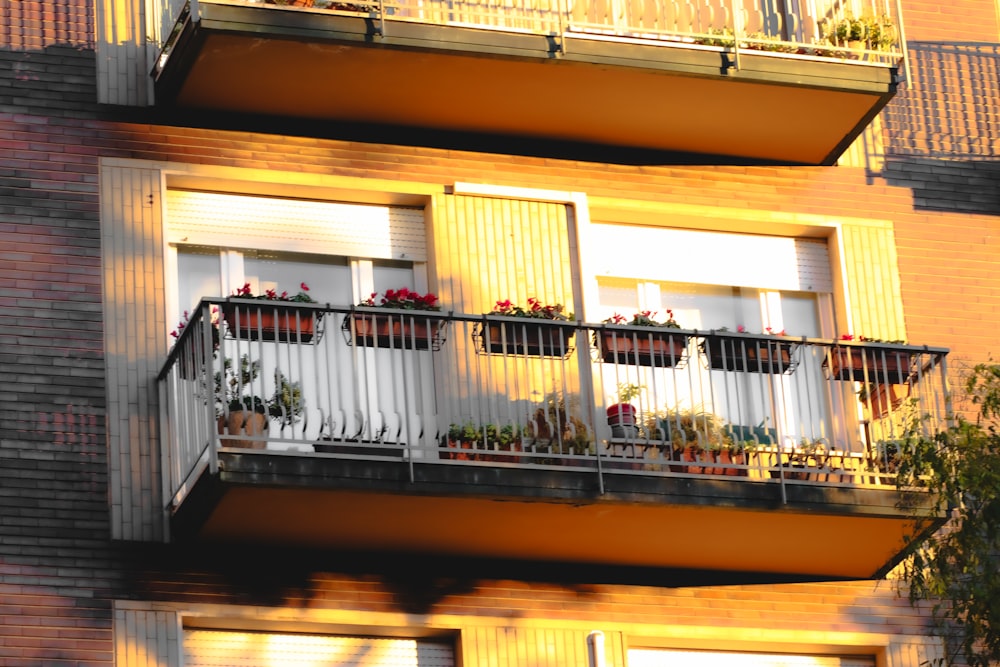 an apartment building with balconies and plants on the balconies