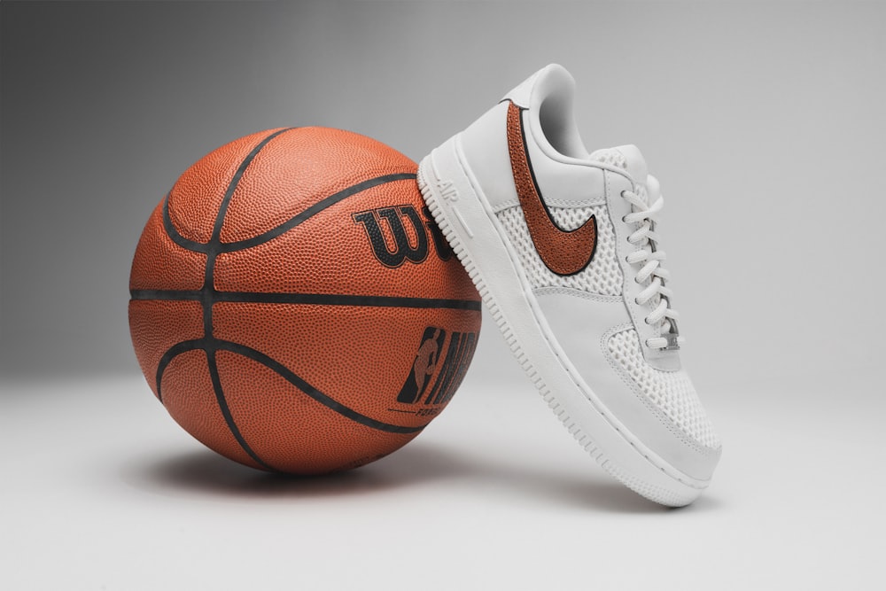 a pair of shoes and a basketball on a gray background