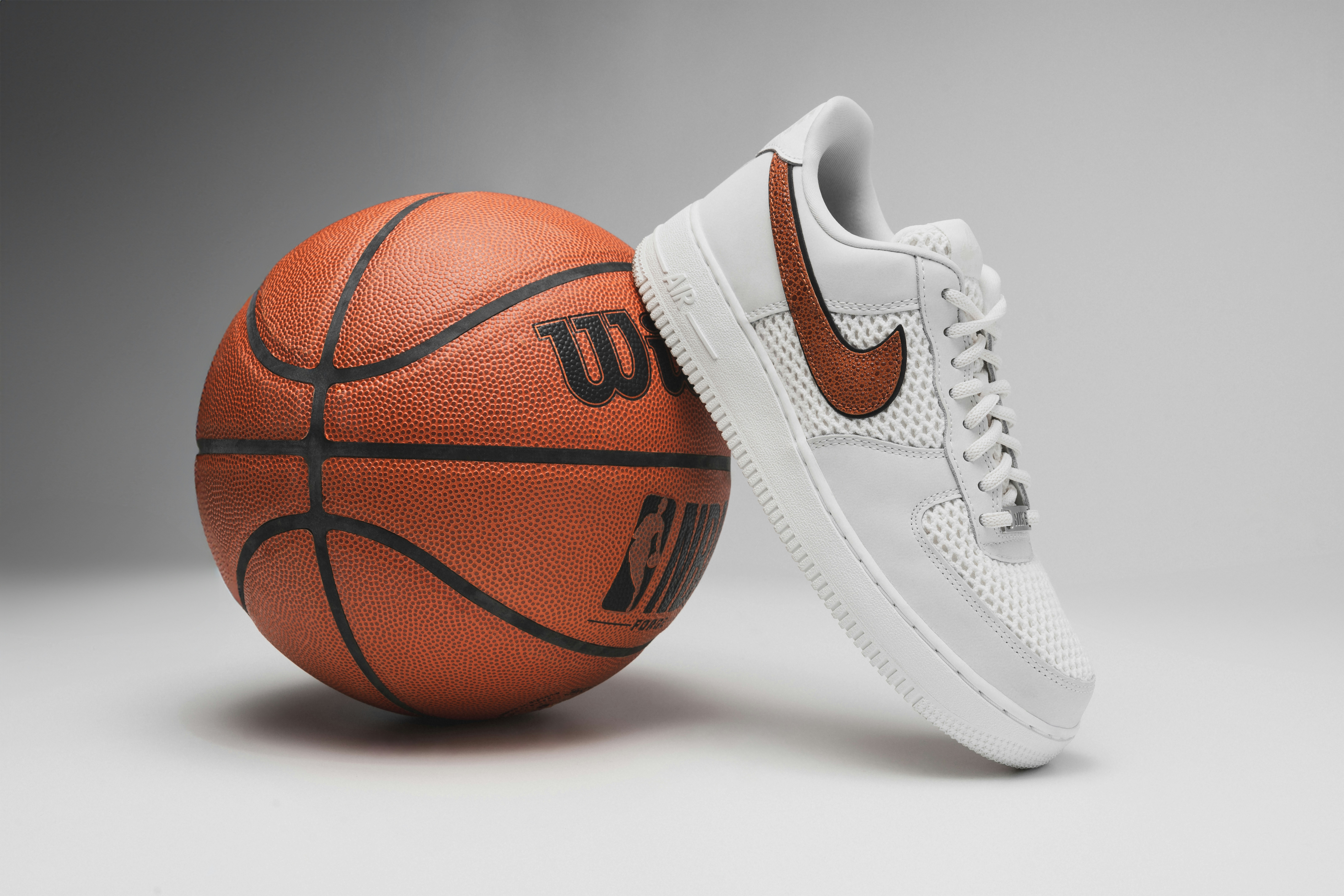 a pair of shoes and a basketball on a gray background