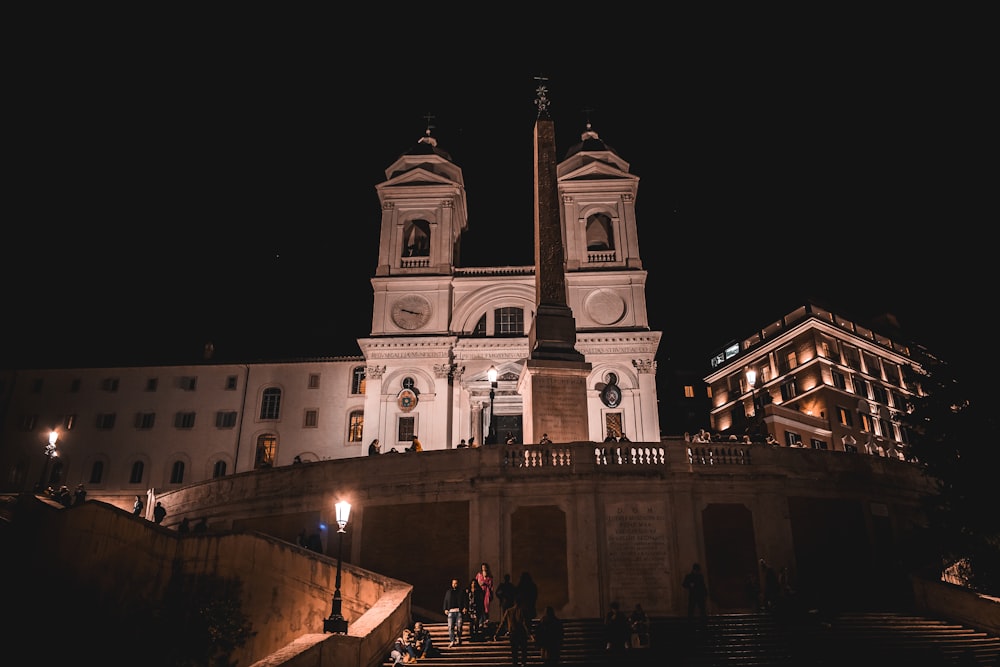 a large white building with two towers at night