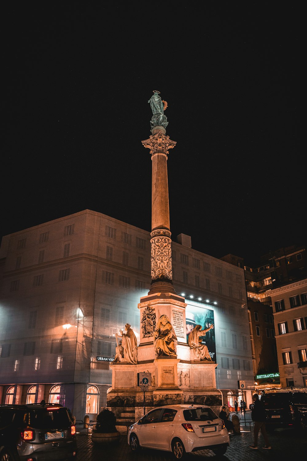 a very tall monument sitting in the middle of a parking lot