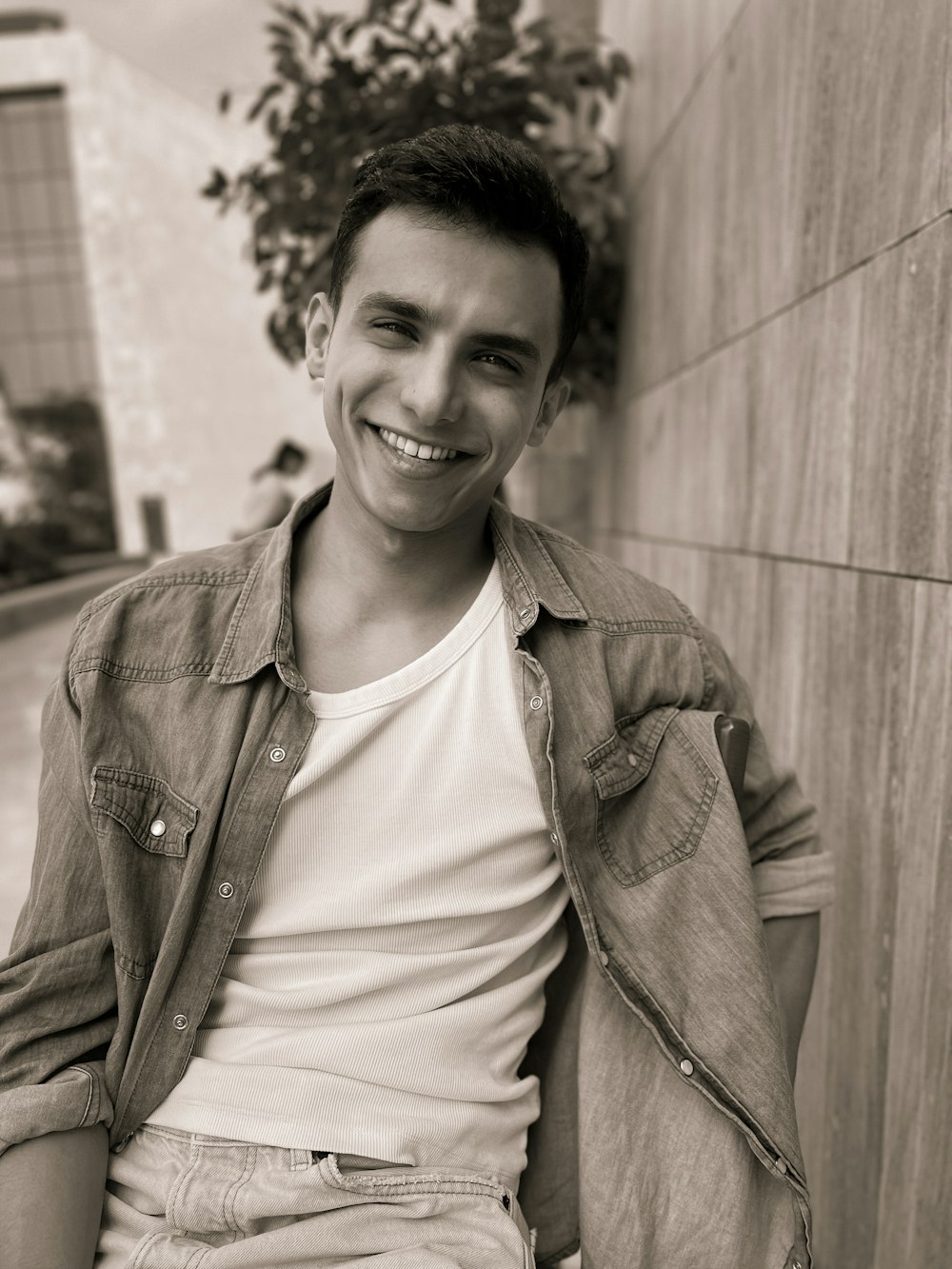 a man sitting on a bench smiling at the camera