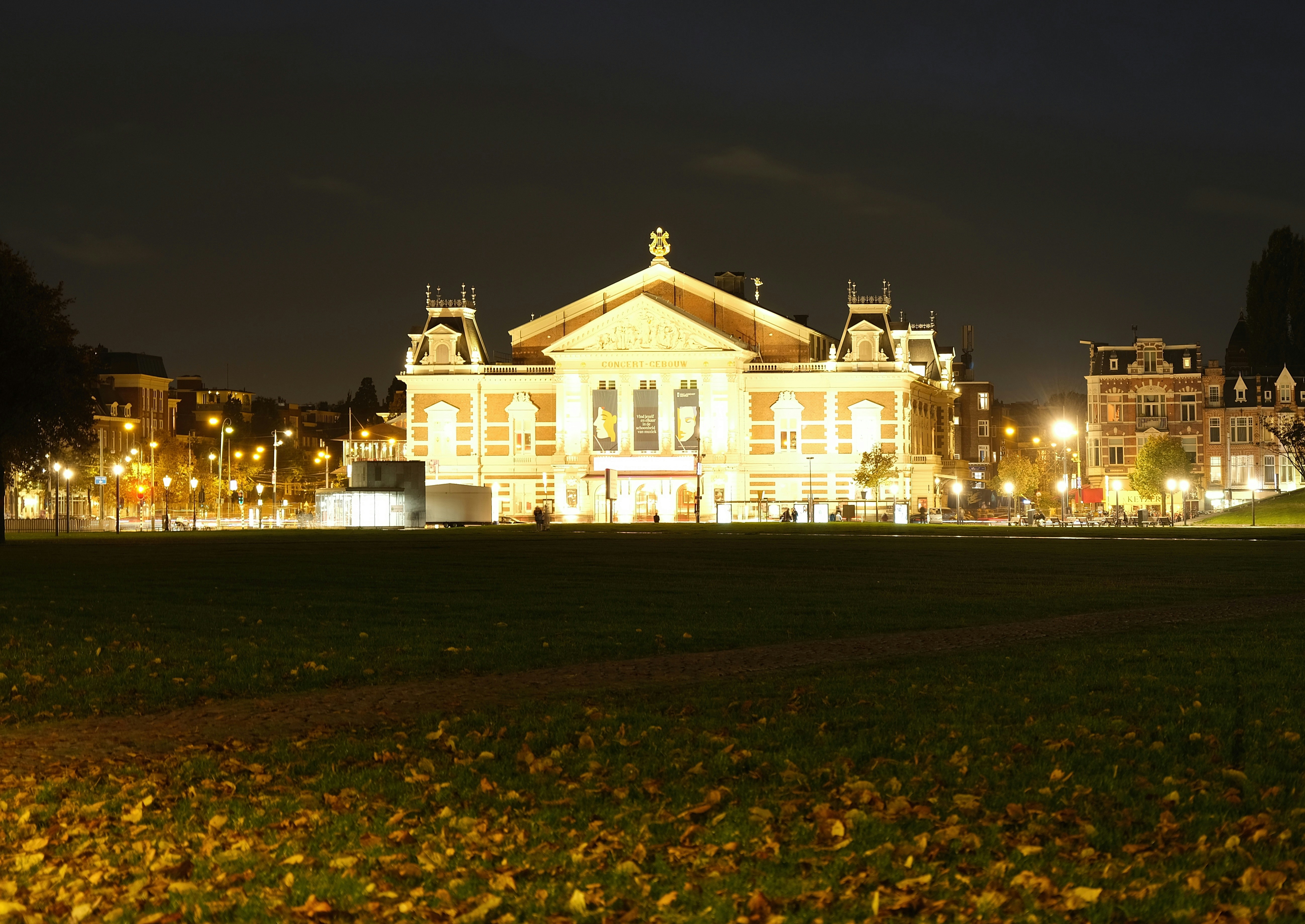 a building lit up at night in a park