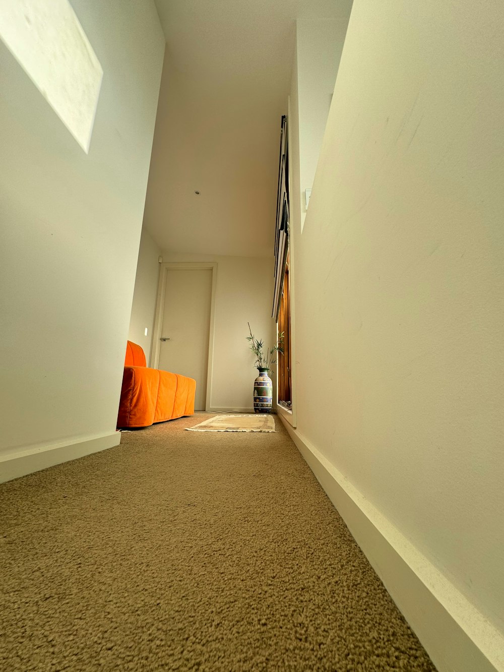 a hallway with a carpeted floor and white walls
