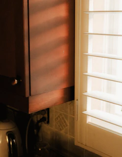 Sunlight streaming through a window onto milk being slowly boiled in an old-fashioned stove
