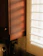 A bright kitchen with morning sunlight streaming over a bowl of fresh fruit and a cup of tea.