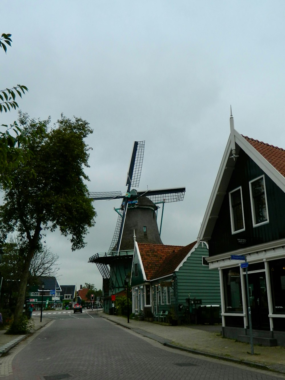 a row of houses with a windmill in the background