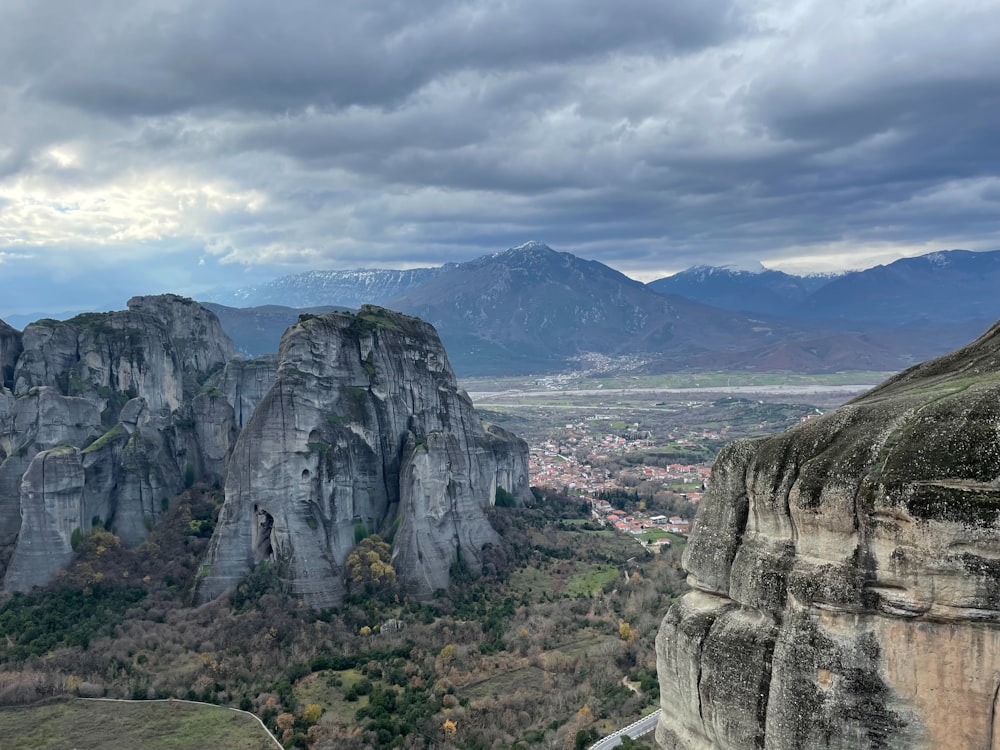 a scenic view of a valley with mountains in the background