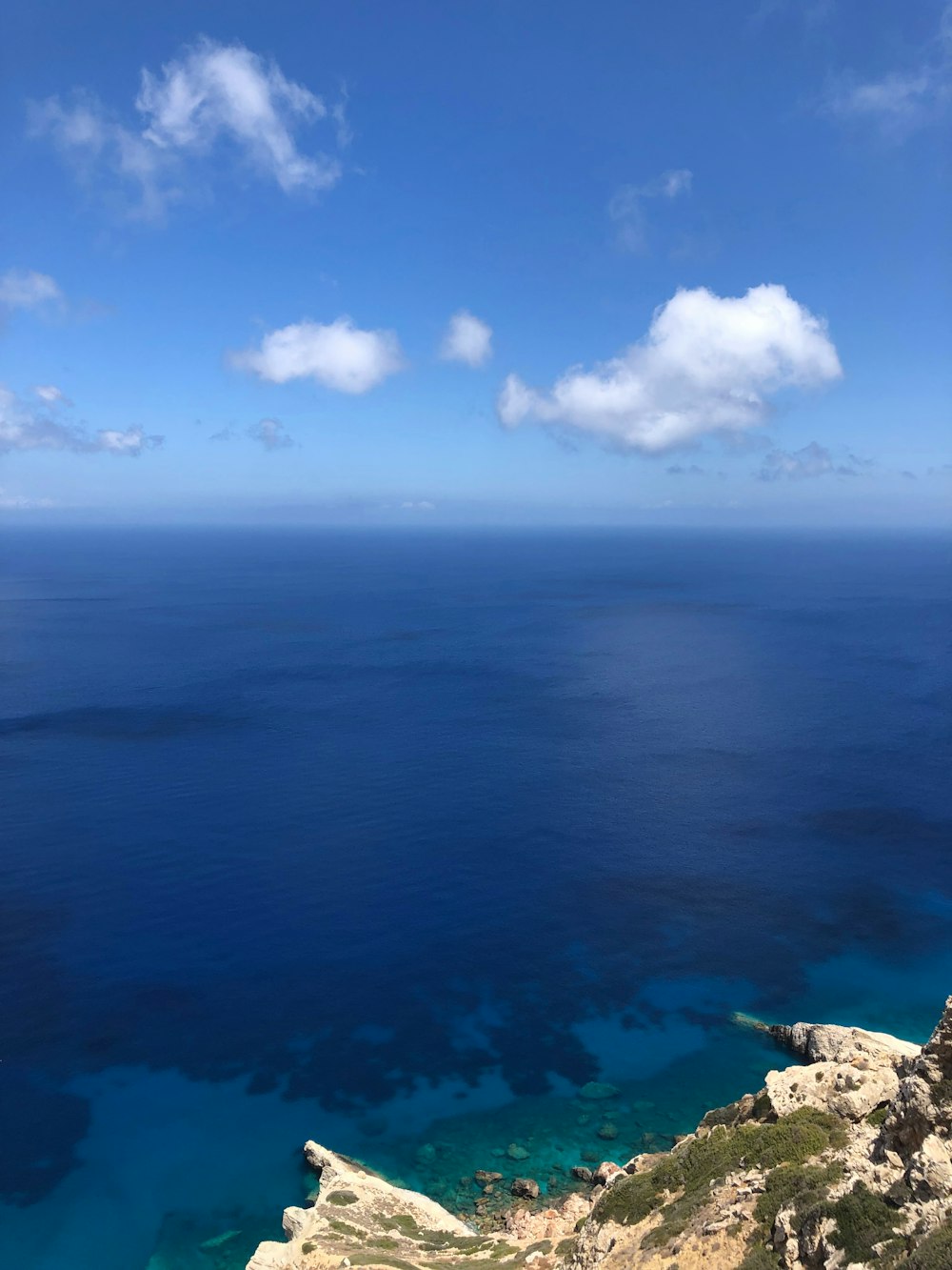 a view of the ocean from the top of a hill