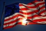 The stars and stripes of the USA flag shining bright in the sunlight.