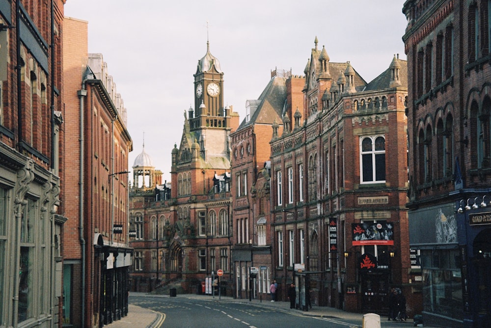 a city street with a clock tower in the background