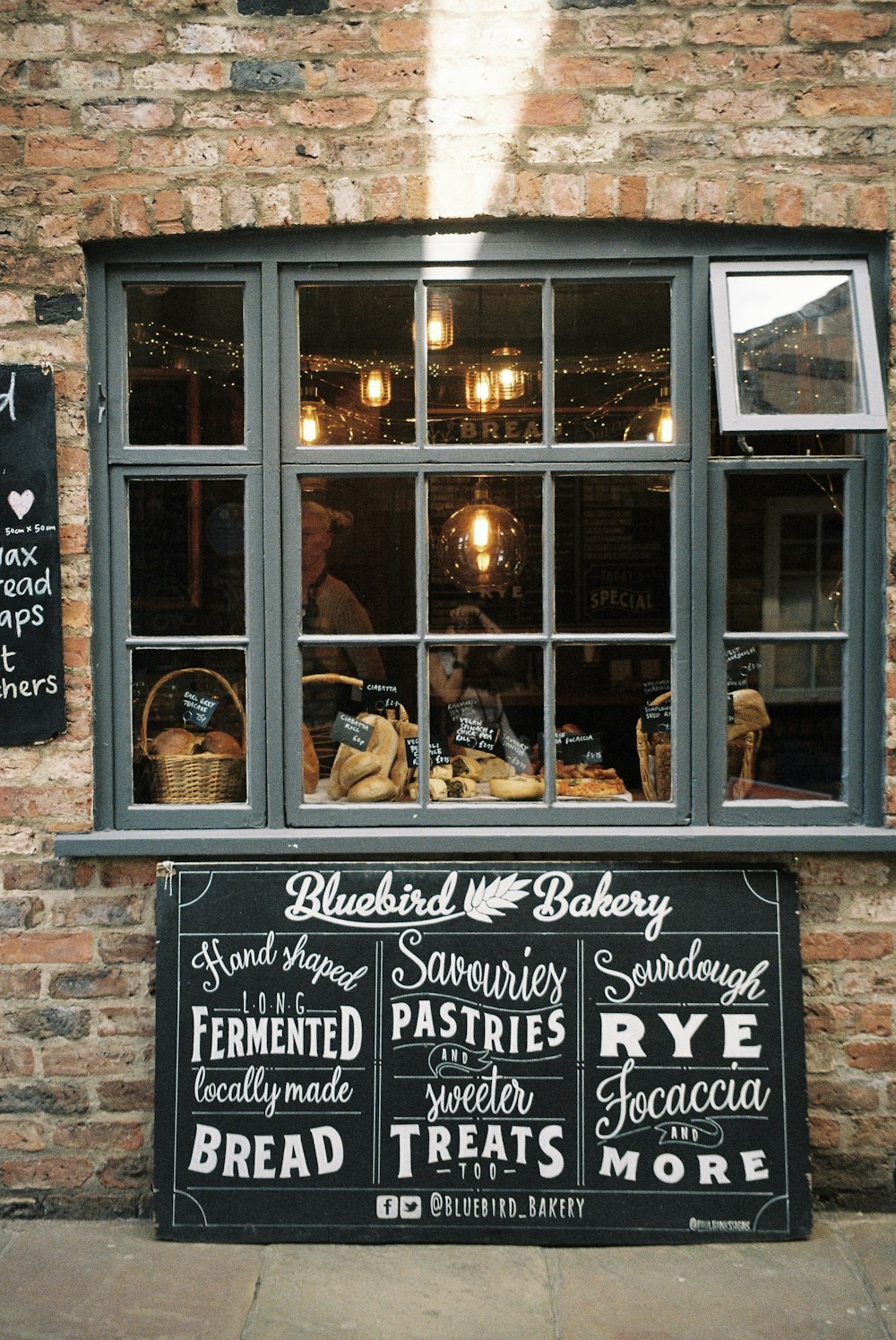 a brick building with a sign for a bakery