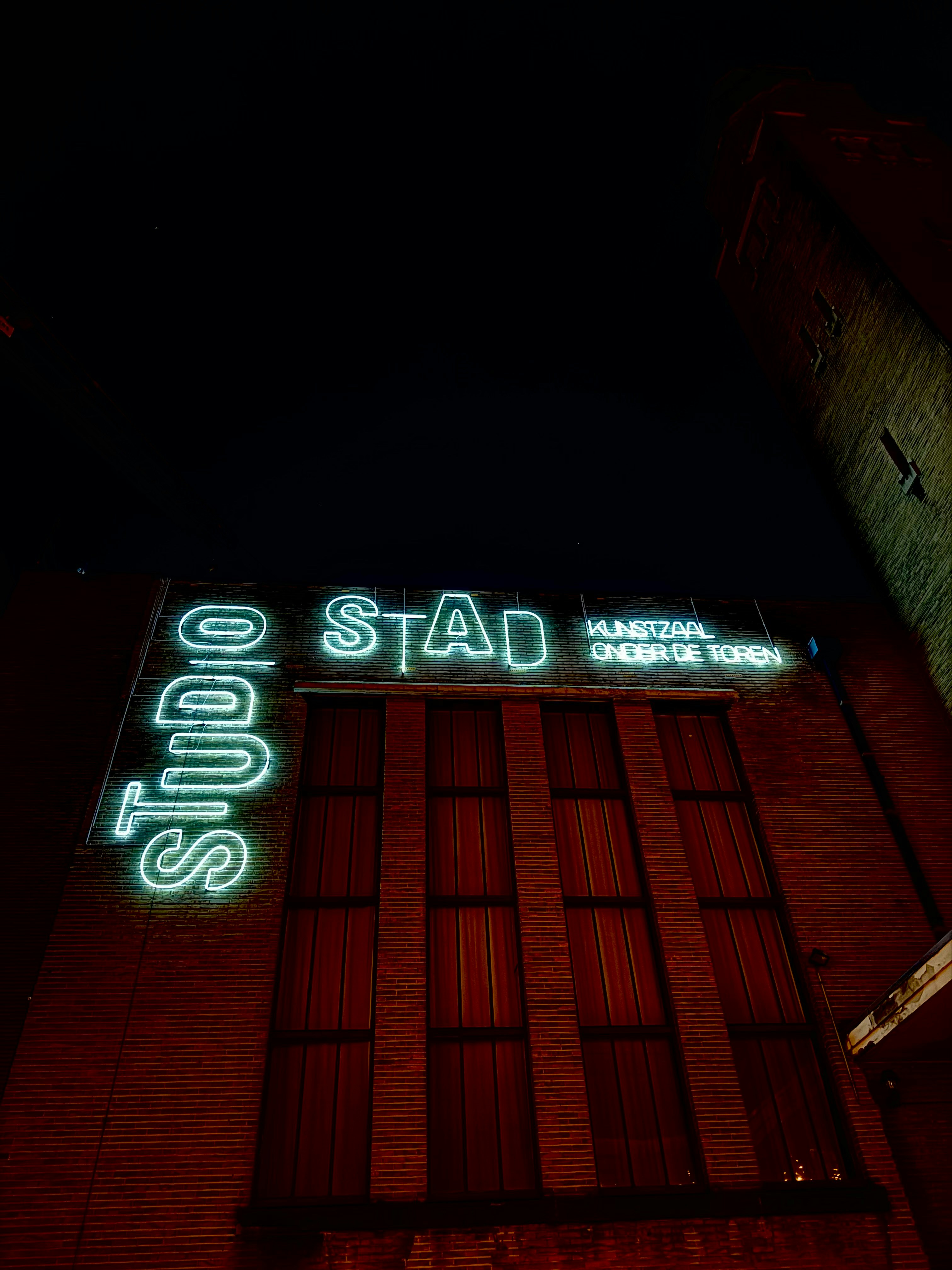 a neon sign on the side of a building