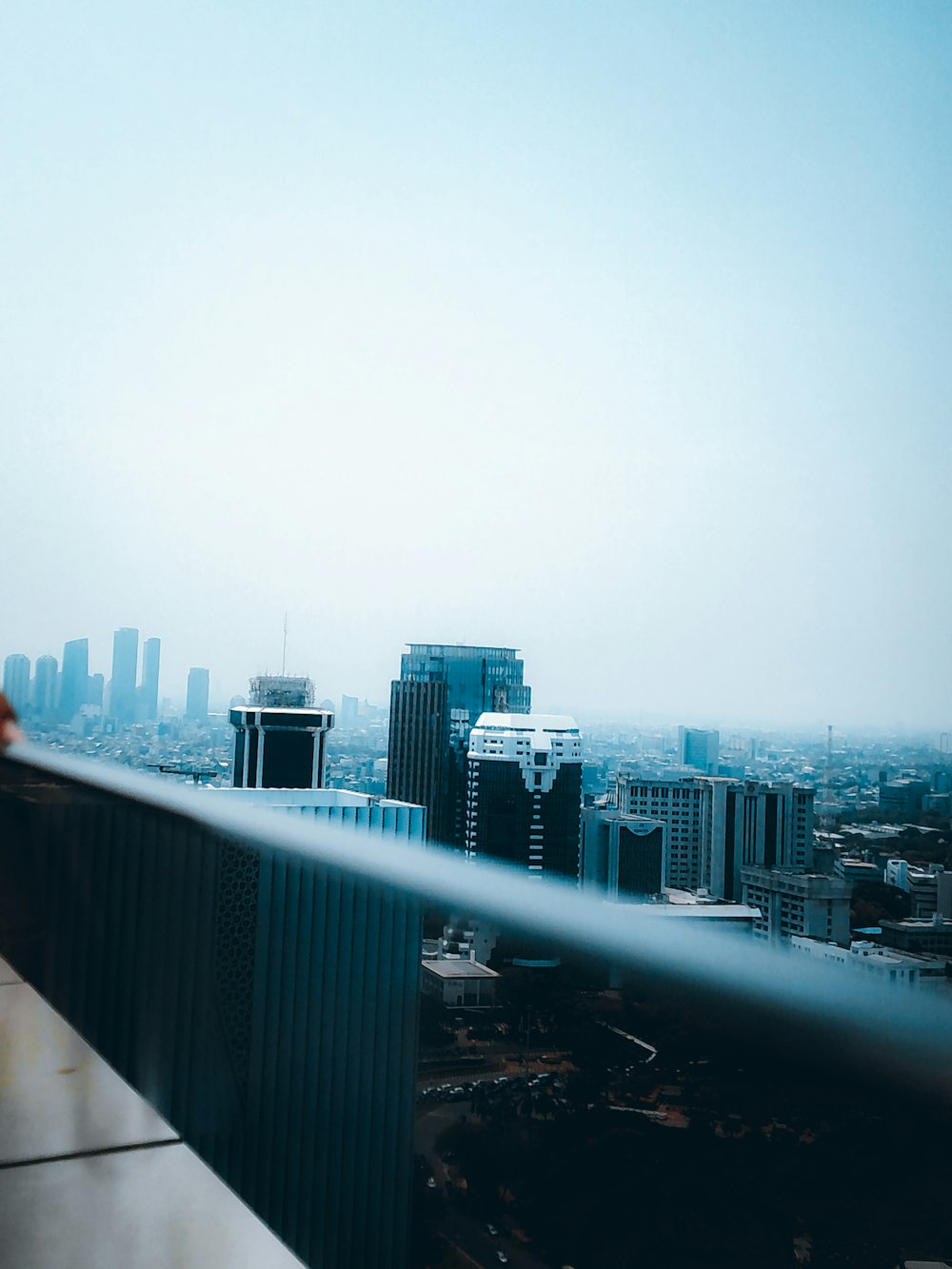 a person standing on a balcony overlooking a city