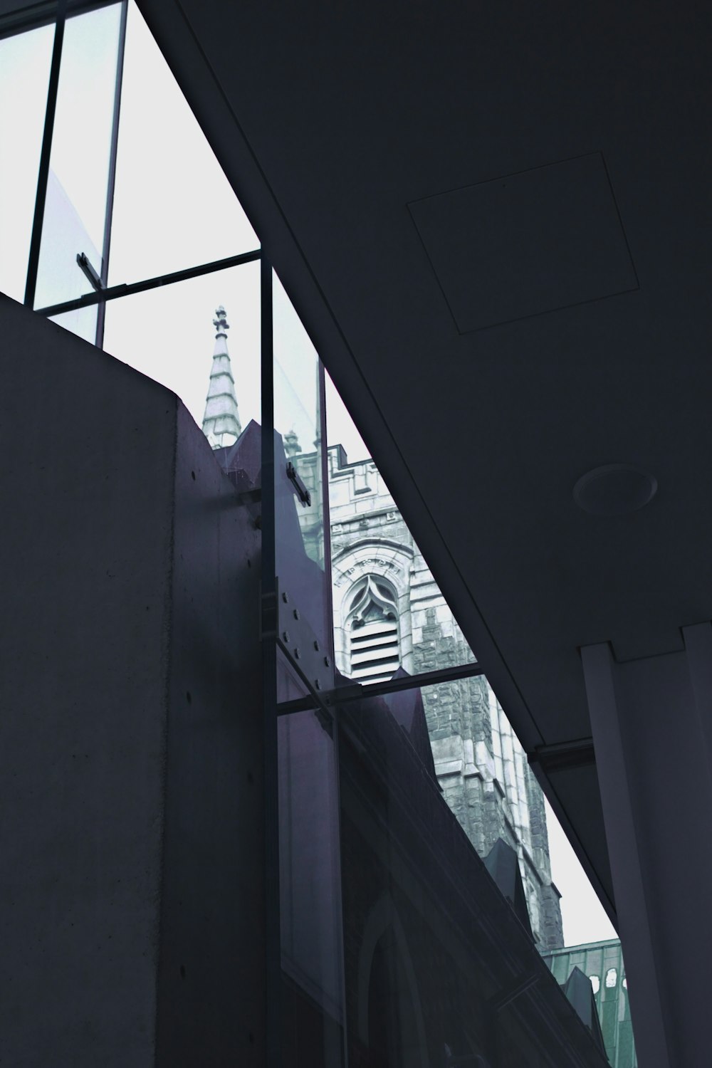 a tall building with a clock tower seen through a window