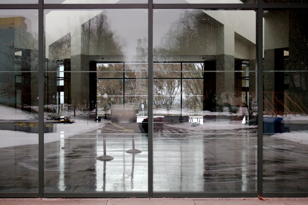 a large glass building with a clock on the front of it