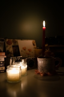An inviting scene of bike candles lit on a table beside cycling gear and a cup of coffee