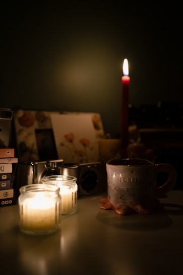 A vibrant, playful scene of a candle melting gently beside a stack of well-loved books and a steaming mug.
