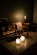 A peaceful workspace with journals and calming candles.