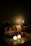 A cozy living room with softly glowing candles on a wooden table.